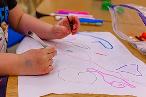 close-up of children's hands making a drawing