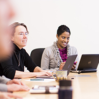 "group of colleagues around a conference table"