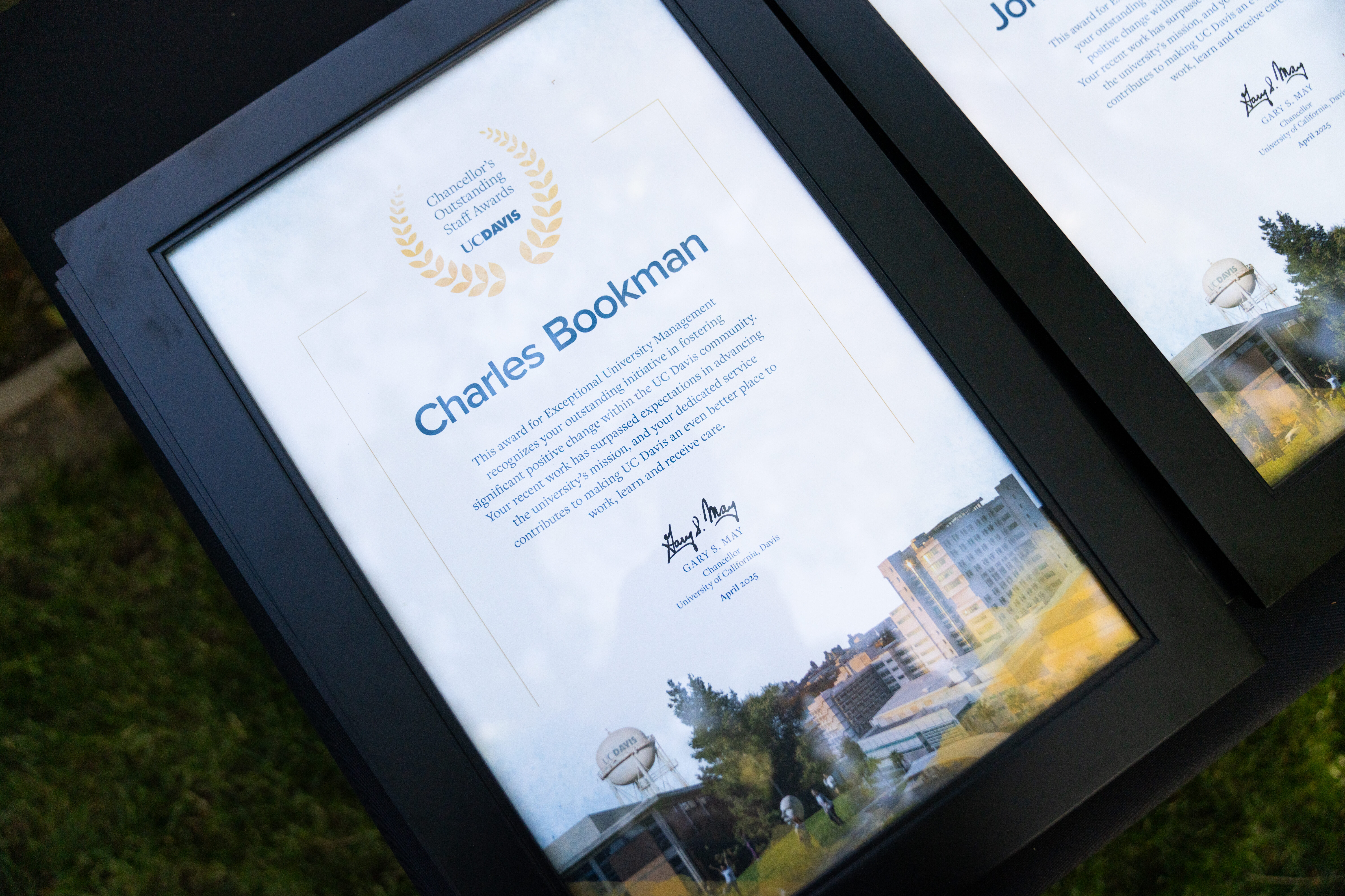 A framed certificate titled "Chancellor's Outstanding Staff Awards – UC Davis" awarded to Charles Bookman.