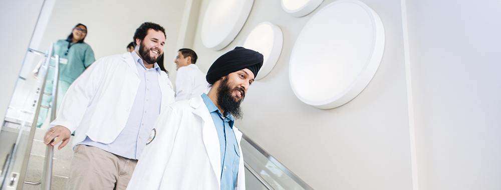 group of medical professionals walking down a flight of stairs