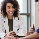 Female doctor smiling at male patient while having a conversation.  